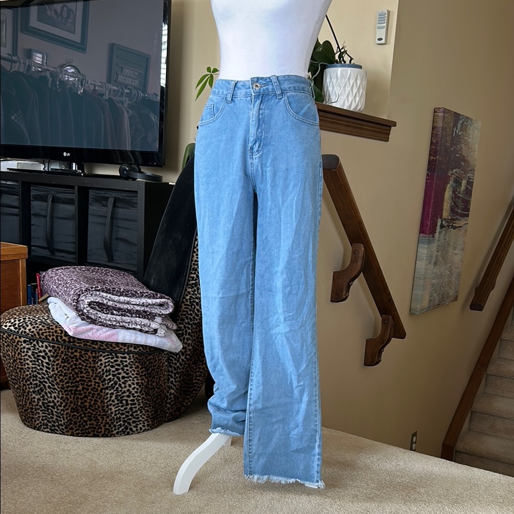 Women's high waisted wide leg Blue Jeans with raw hem